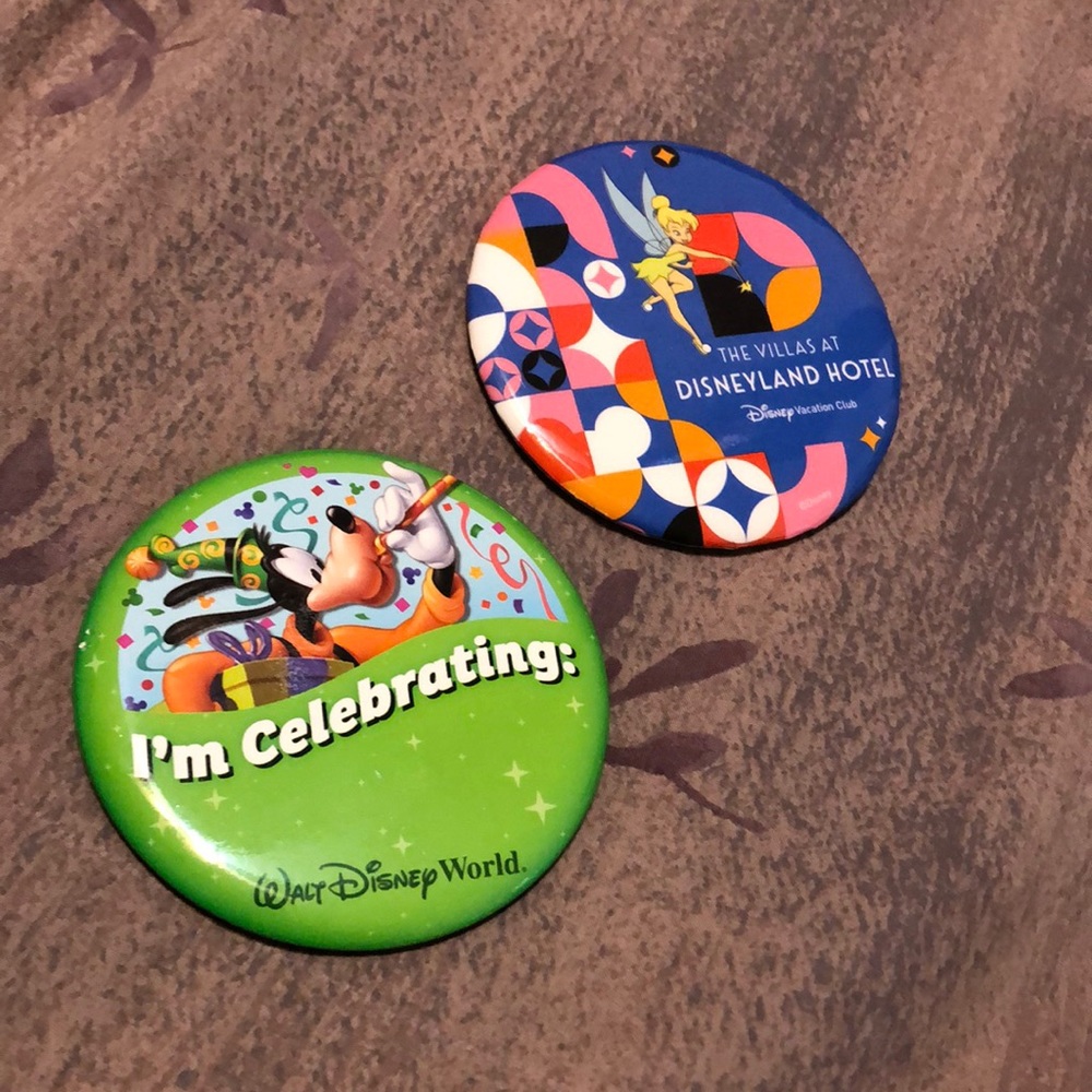 Two Disney buttons. I’m Celebrating: can be customized and Disneyland Villas.